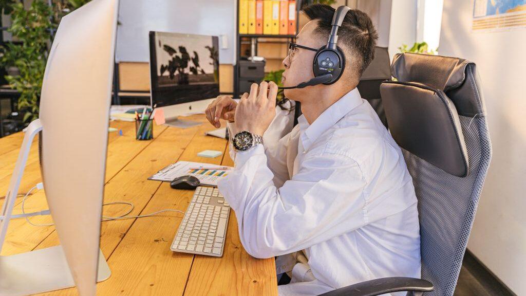 man in suit and tie working at a computer